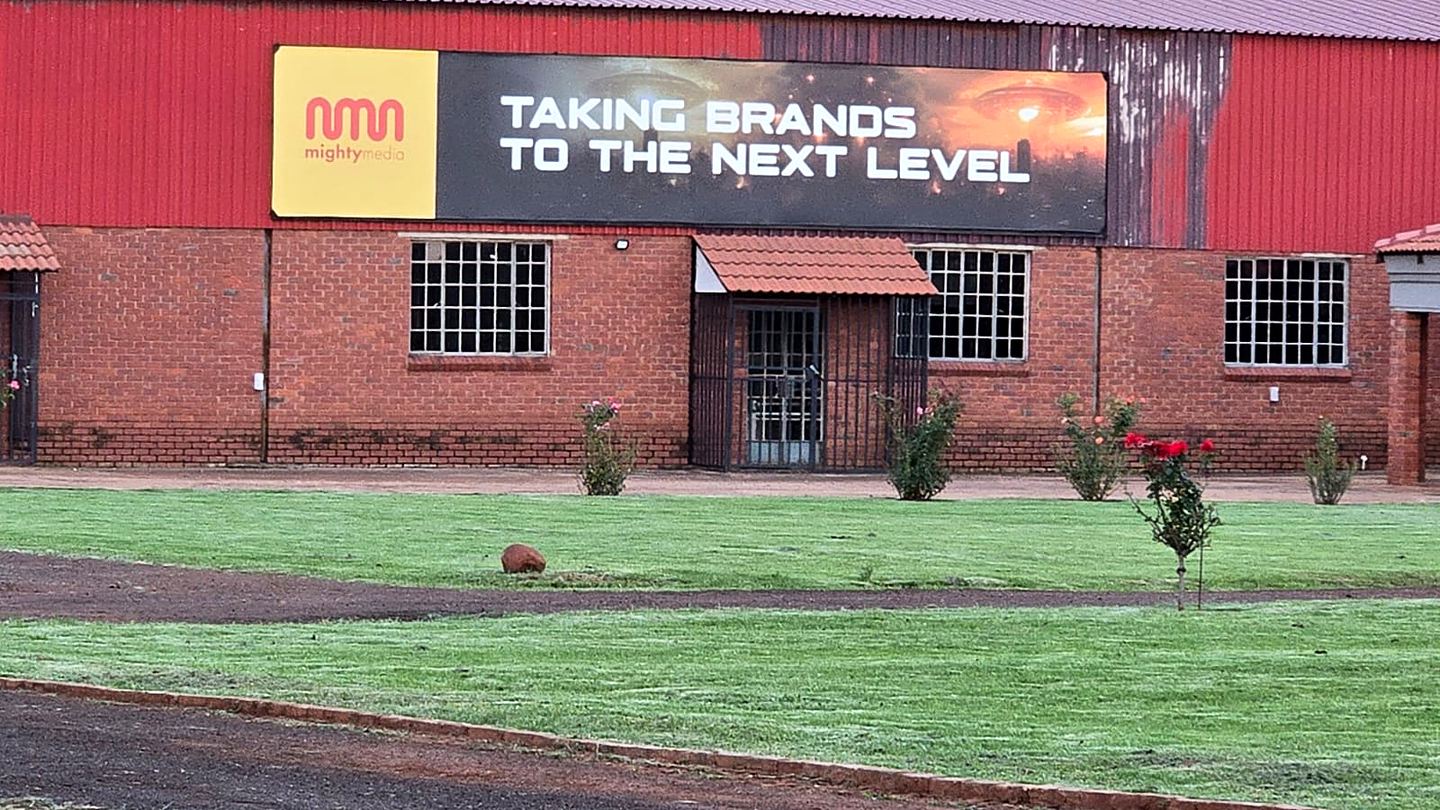 Mighty Media building banner reading Taking brands to the next level