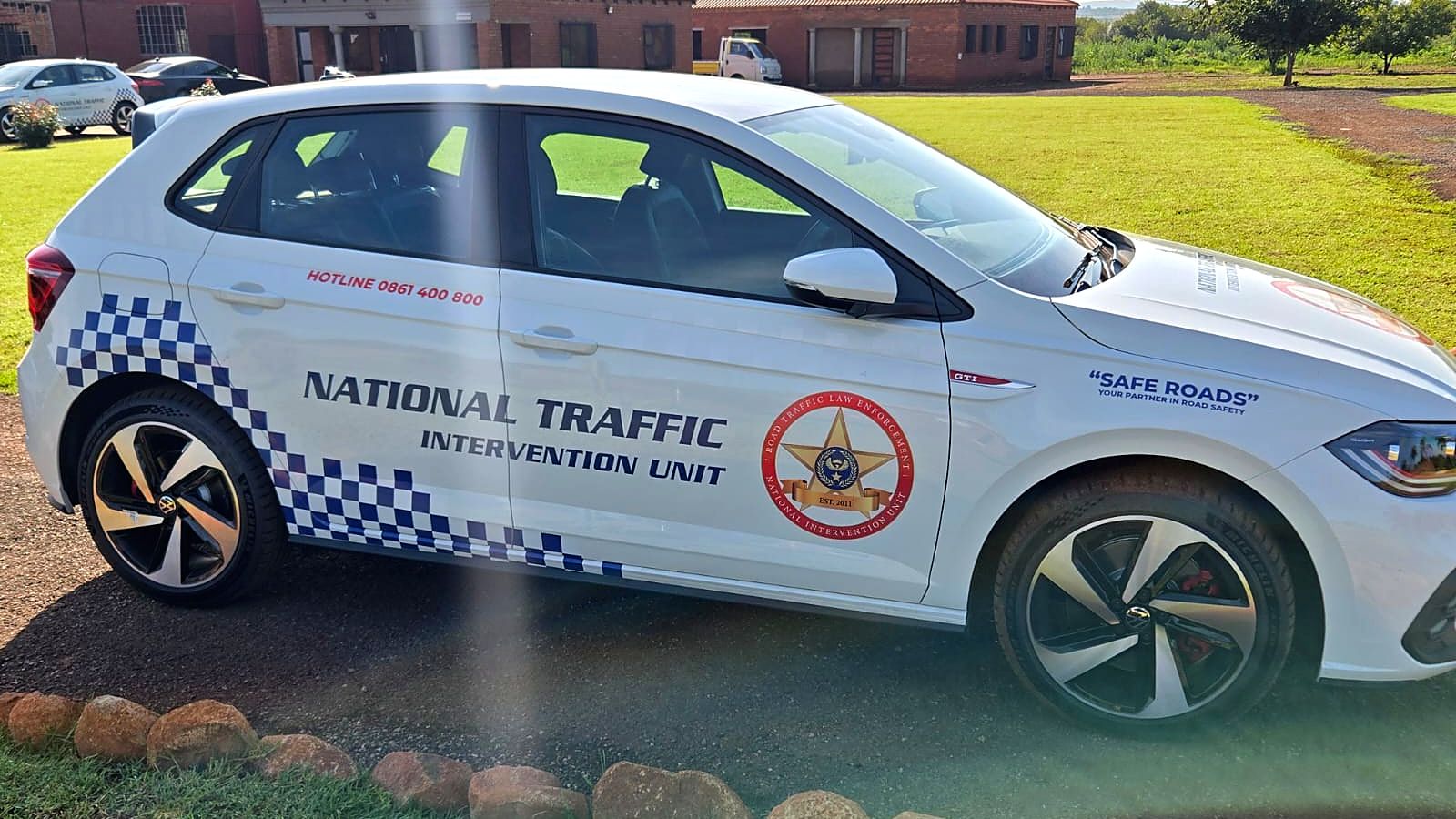 Side view of a VW Polo with National Traffic Intervention Unit branding and chequered decals